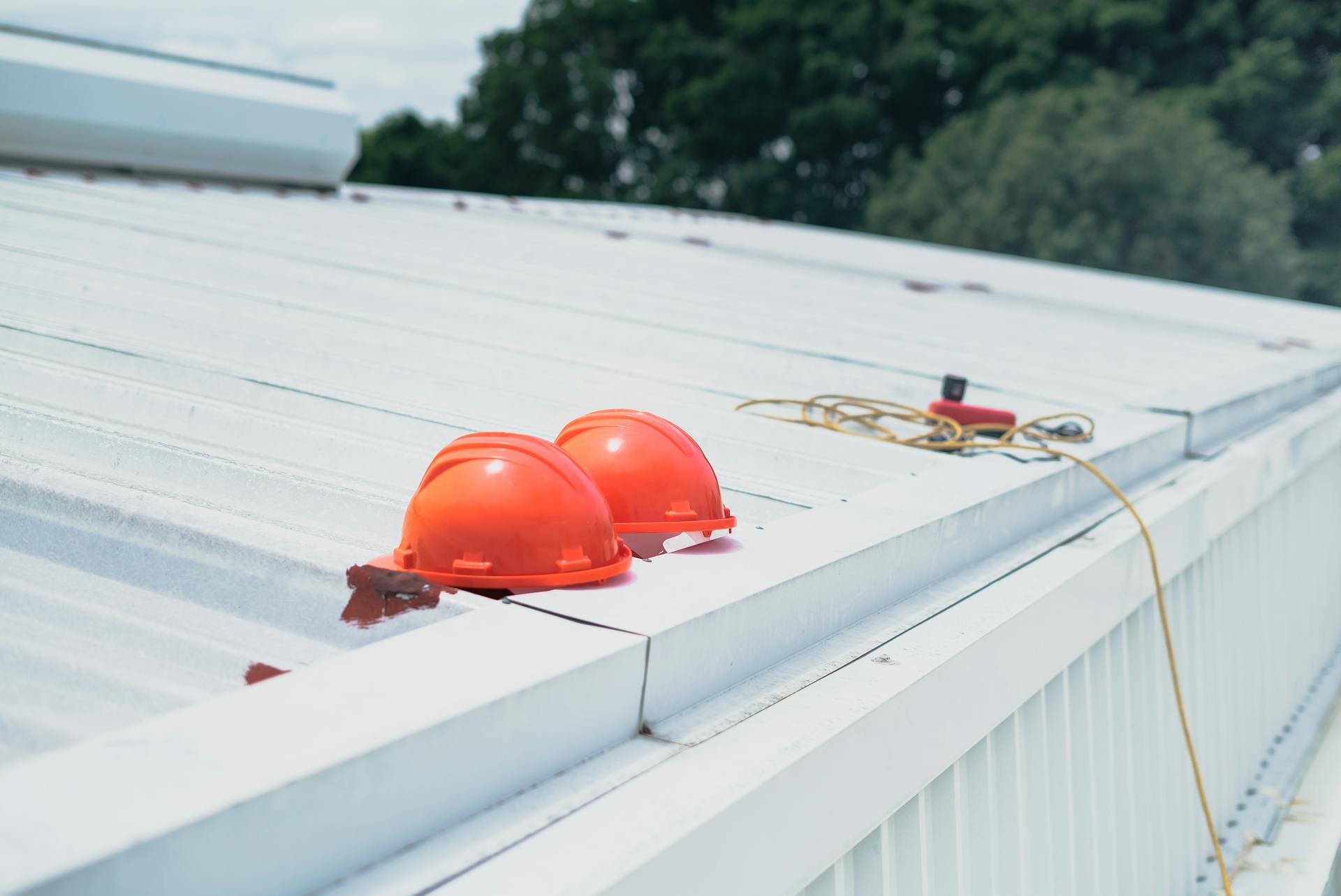 Roofing contractor hard hats on a commercial roofing system in Atlanta