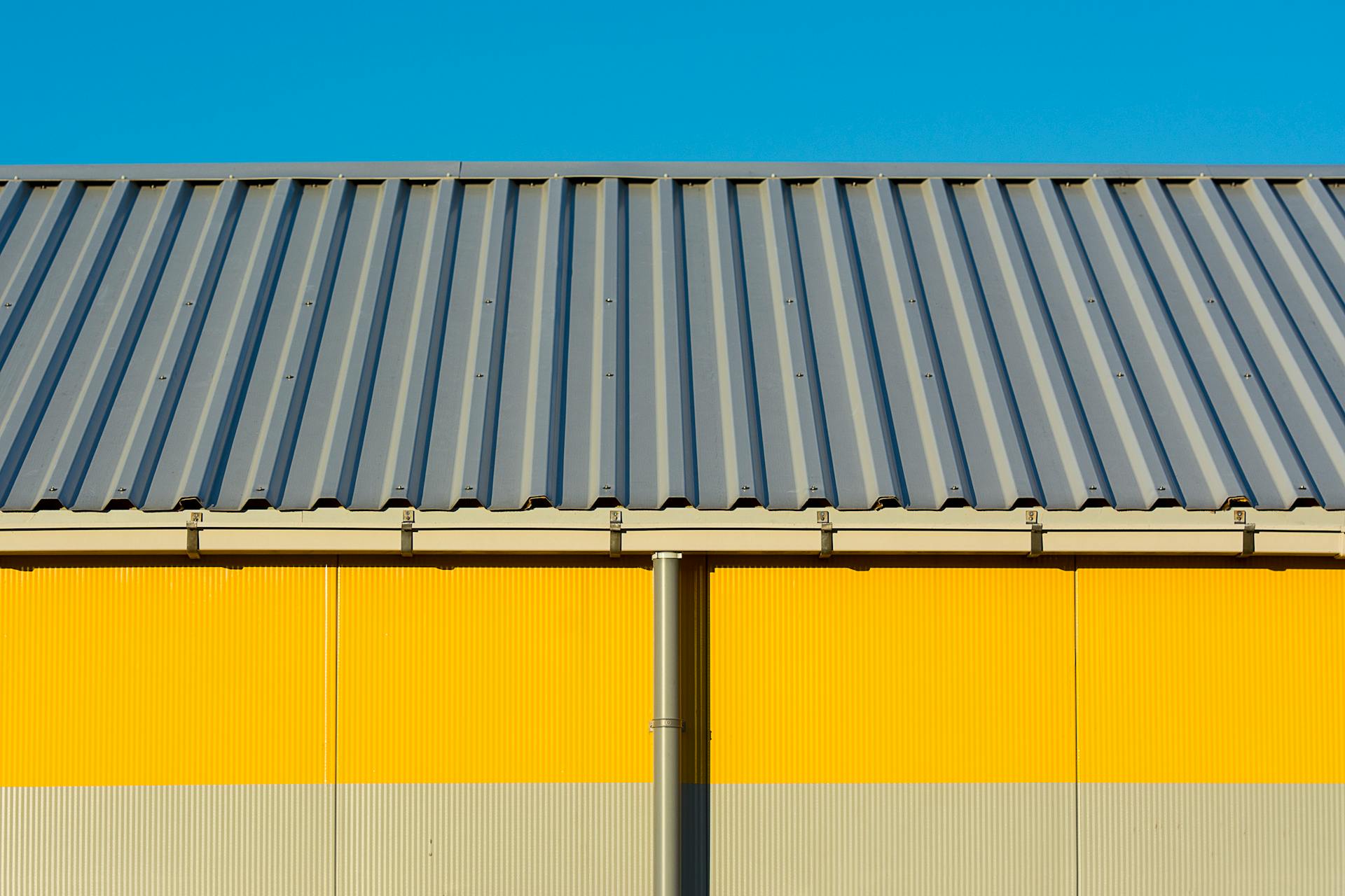A commercial roofing system on a yellow building in Atlanta